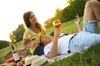 Happy couple having picnic in park on sunny day