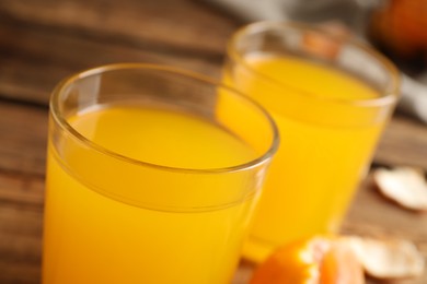 Glass of fresh tangerine juice, closeup view