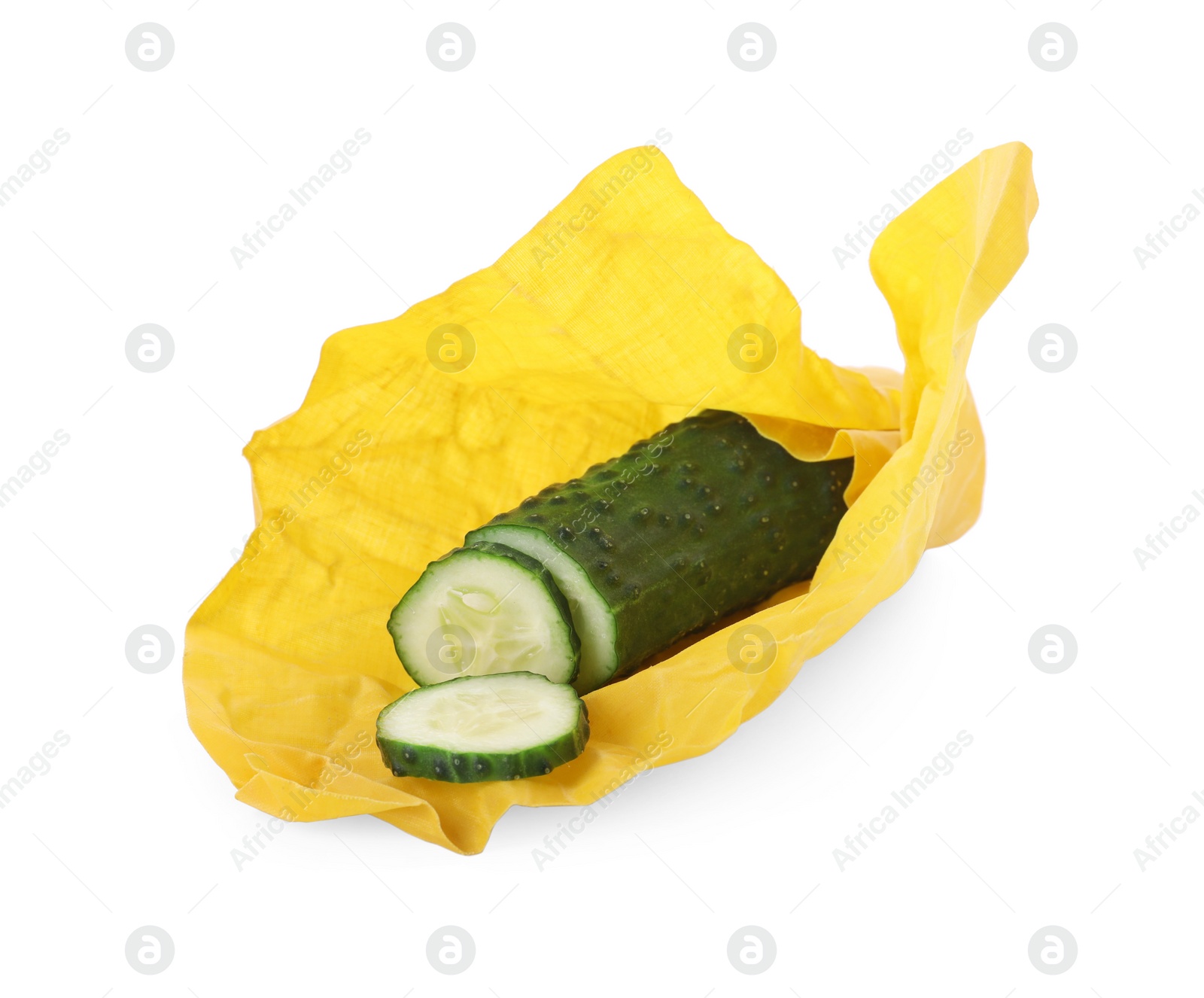 Photo of Fresh cucumber in beeswax food wrap isolated on white