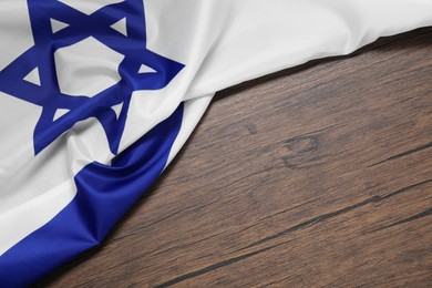 Photo of Flag of Israel on wooden background, above view and space for text. National symbol