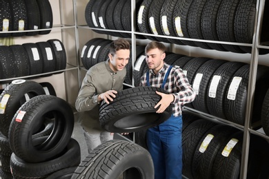 Photo of Service center consultant helping customer to choose tire in store