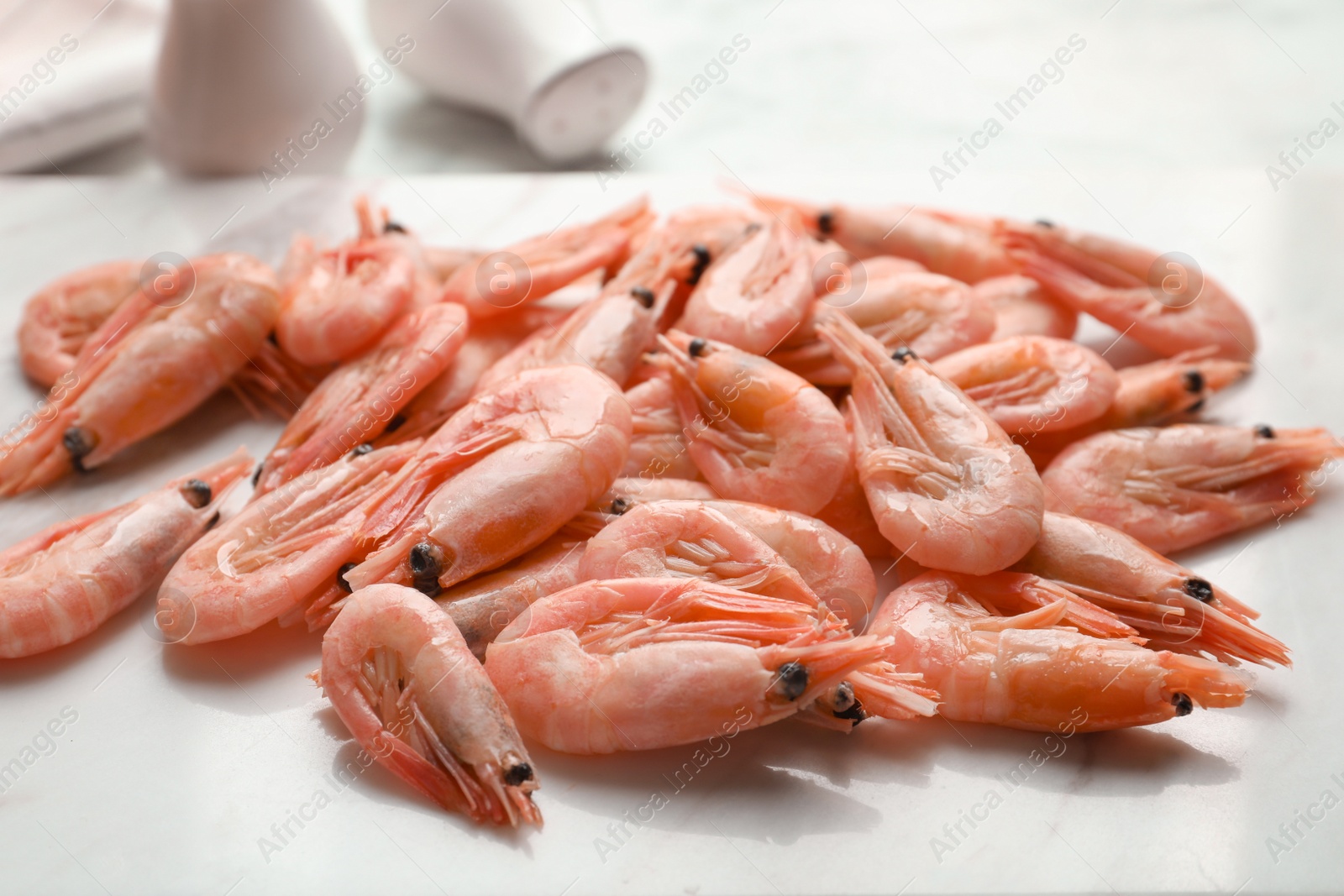 Photo of Fresh raw shrimps on board, closeup