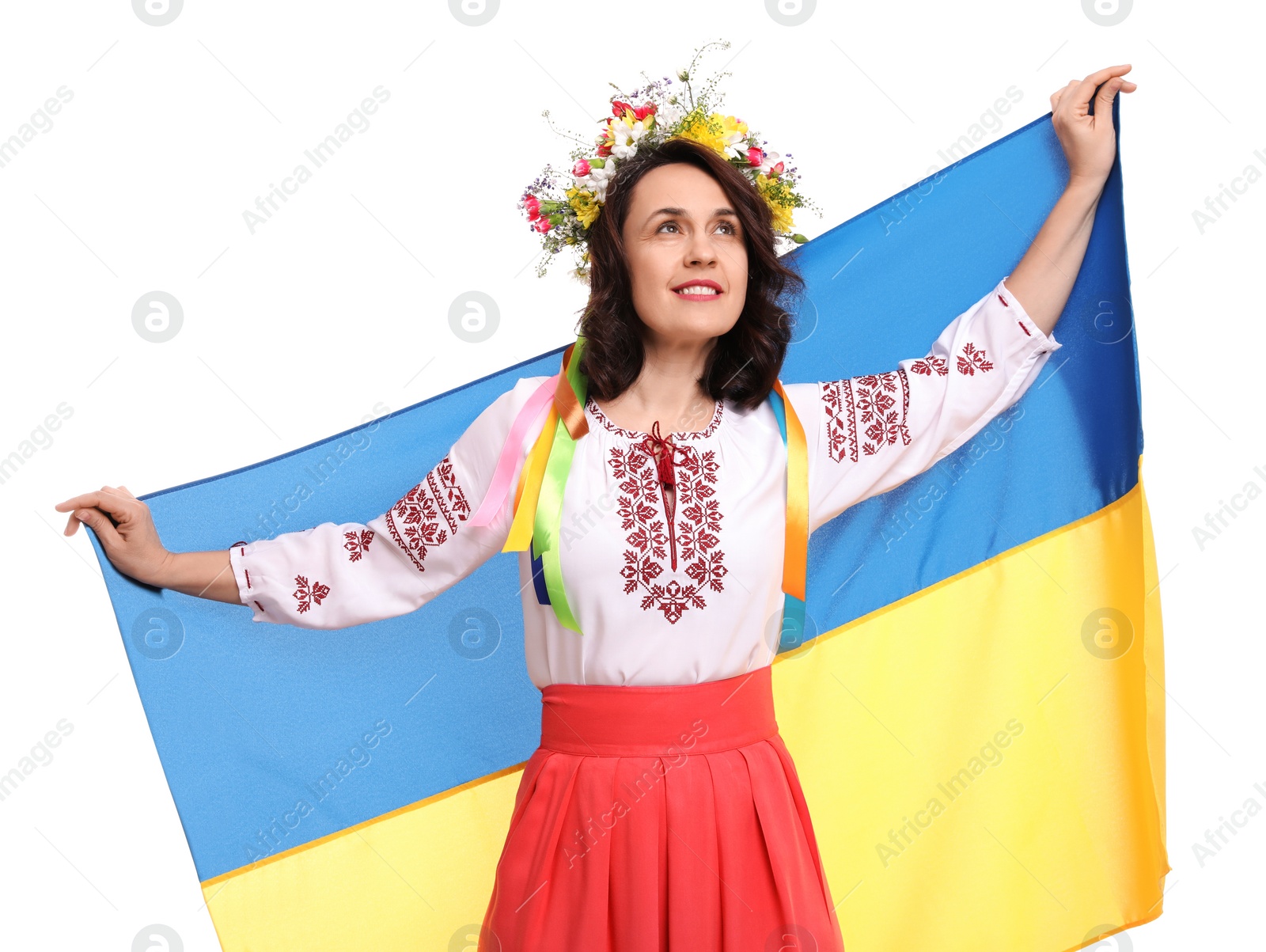 Photo of Happy woman in national clothes with flag of Ukraine on white background