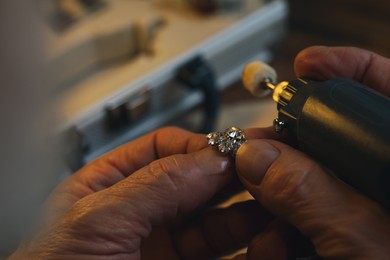 Photo of Professional jeweler working with gemstones, closeup view