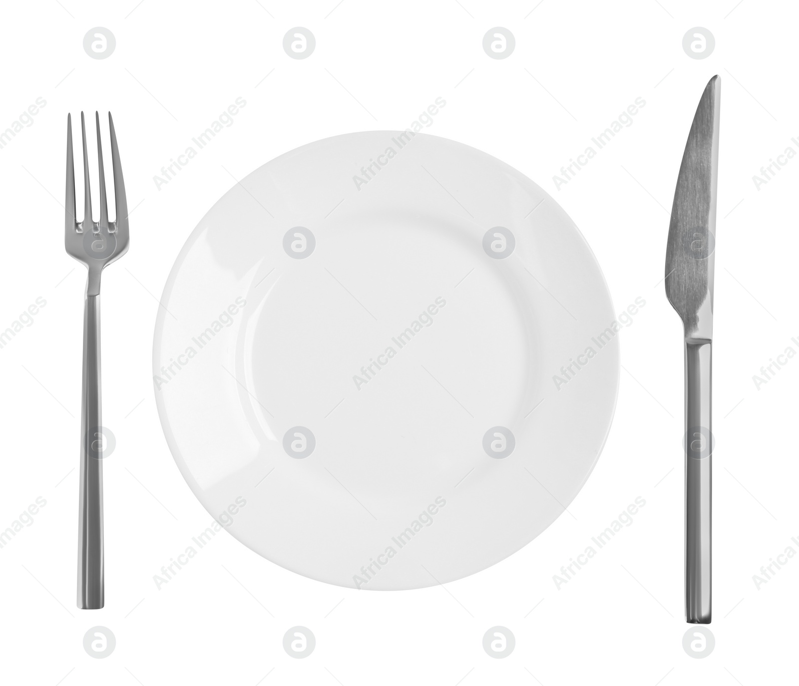 Photo of Clean plate and shiny cutlery on white background, top view