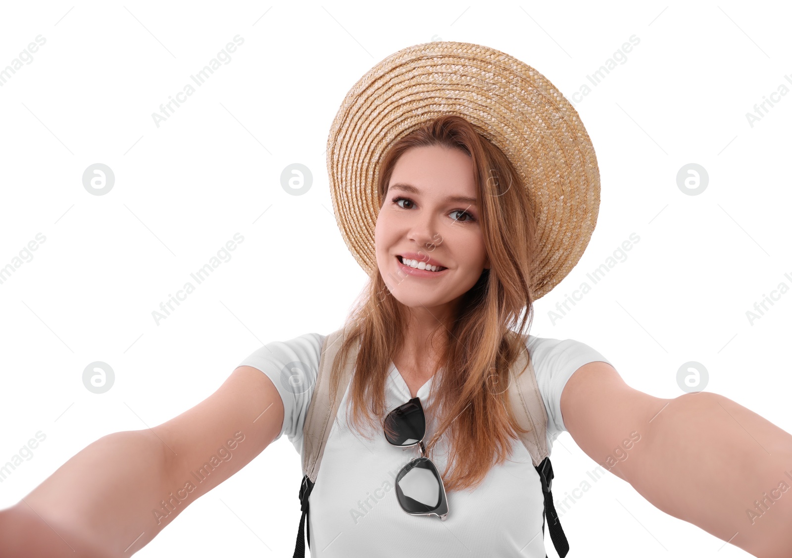 Photo of Beautiful woman in straw hat taking selfie on white background