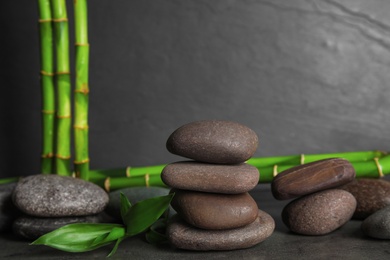 Photo of Composition with stones and bamboo on table. Zen concept