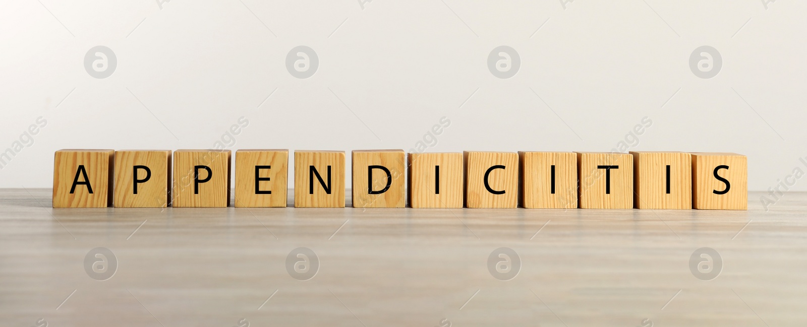 Photo of Word Appendicitis made of cubes with letters on wooden table