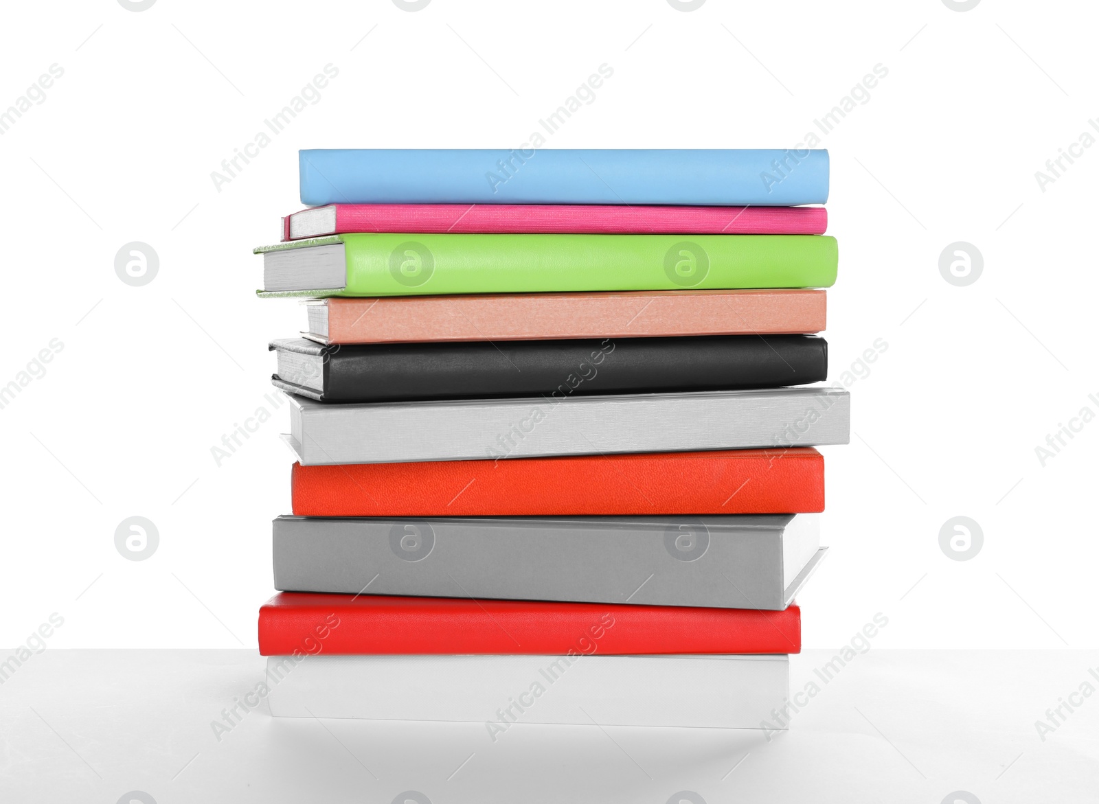 Photo of Stack of different books on white background