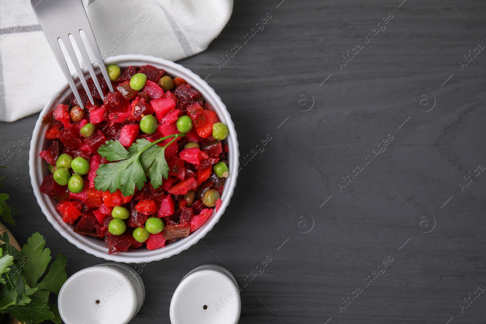 Photo of Delicious vinaigrette salad on grey wooden table, flat lay. Space for text