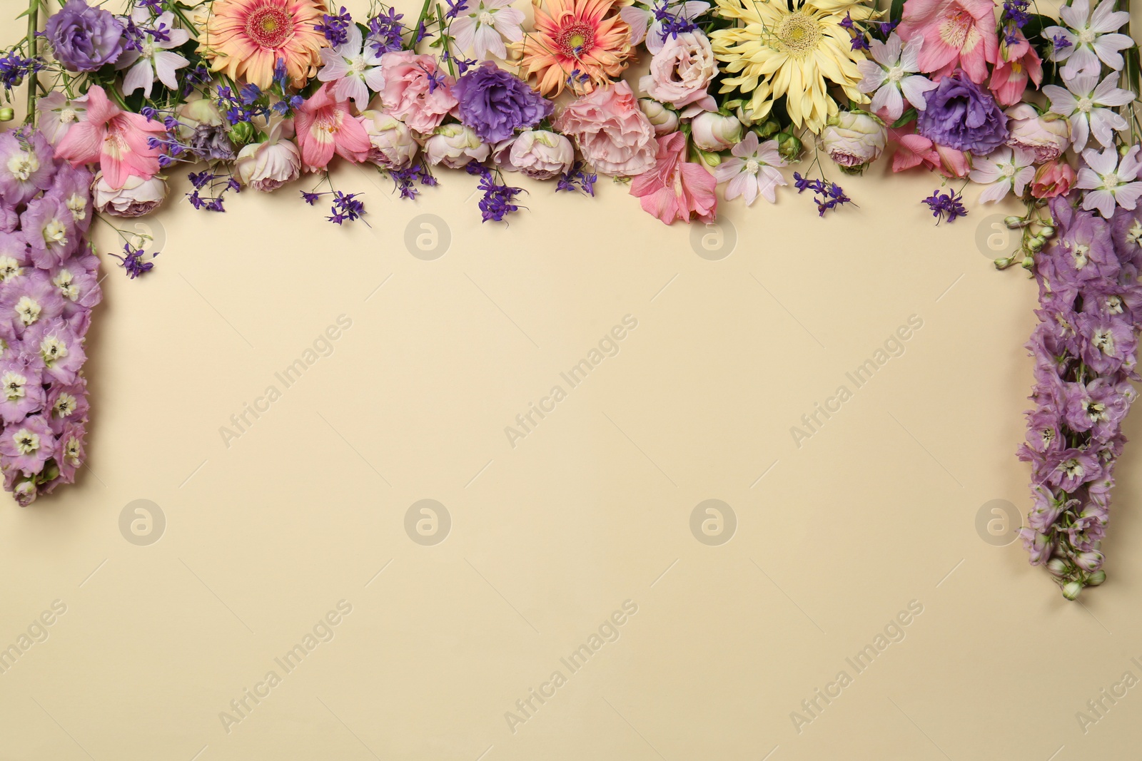 Photo of Flat lay composition with different beautiful flowers on beige background, space for text