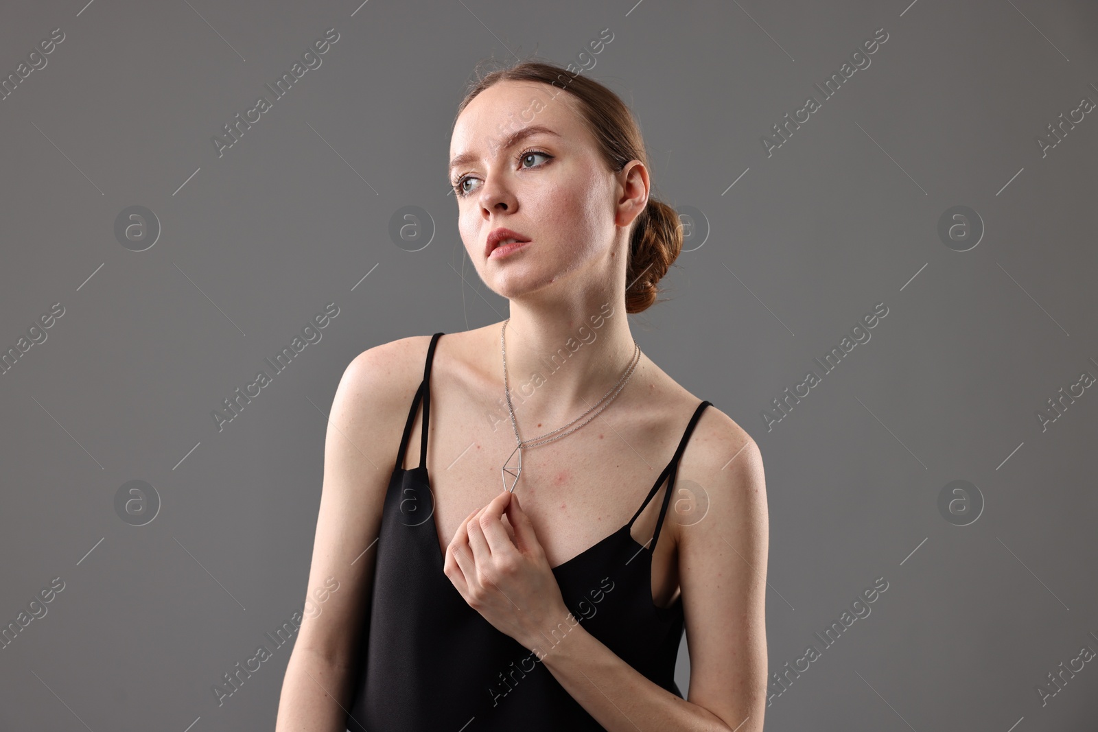 Photo of Fashionable portrait of beautiful young woman on grey background