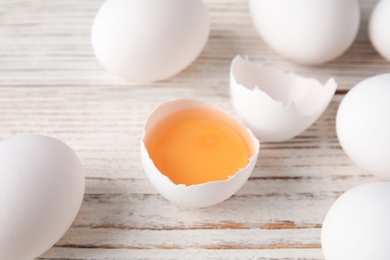 Few raw chicken eggs on wooden background