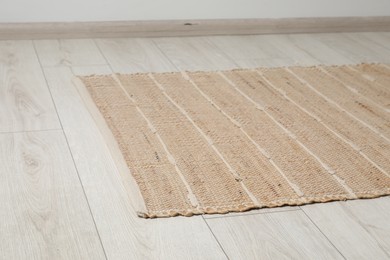 Soft carpet with pattern on white laminated floor indoors