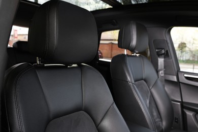 Photo of Seats inside of modern black car, closeup view