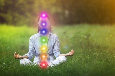 Image of Young woman meditating on green grass. Scheme of seven chakras, illustration