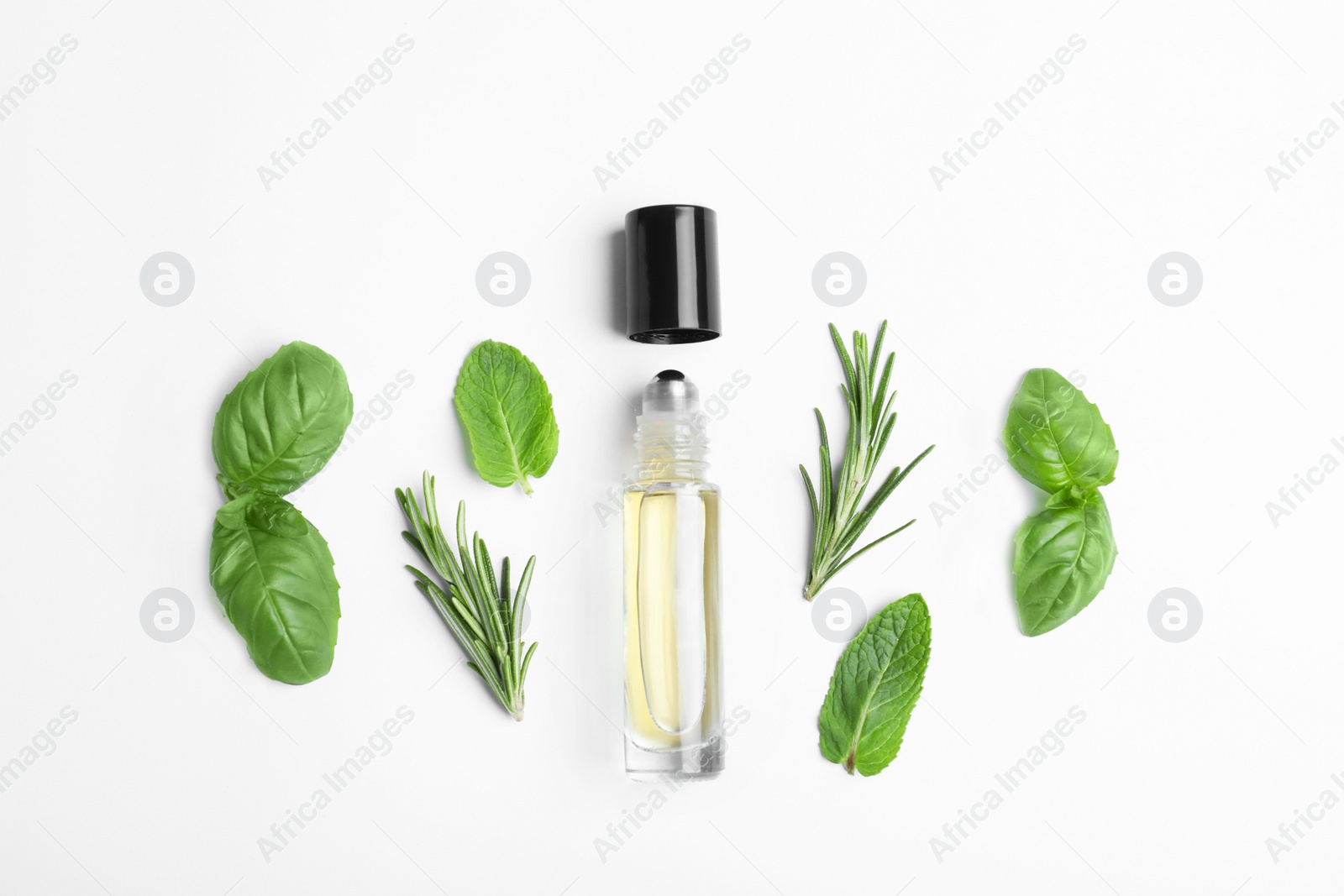 Photo of Little bottle of essential oil with different herbs on white background, top view