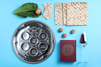 Photo of Flat lay composition with symbolic Pesach (Passover Seder) items on light blue background