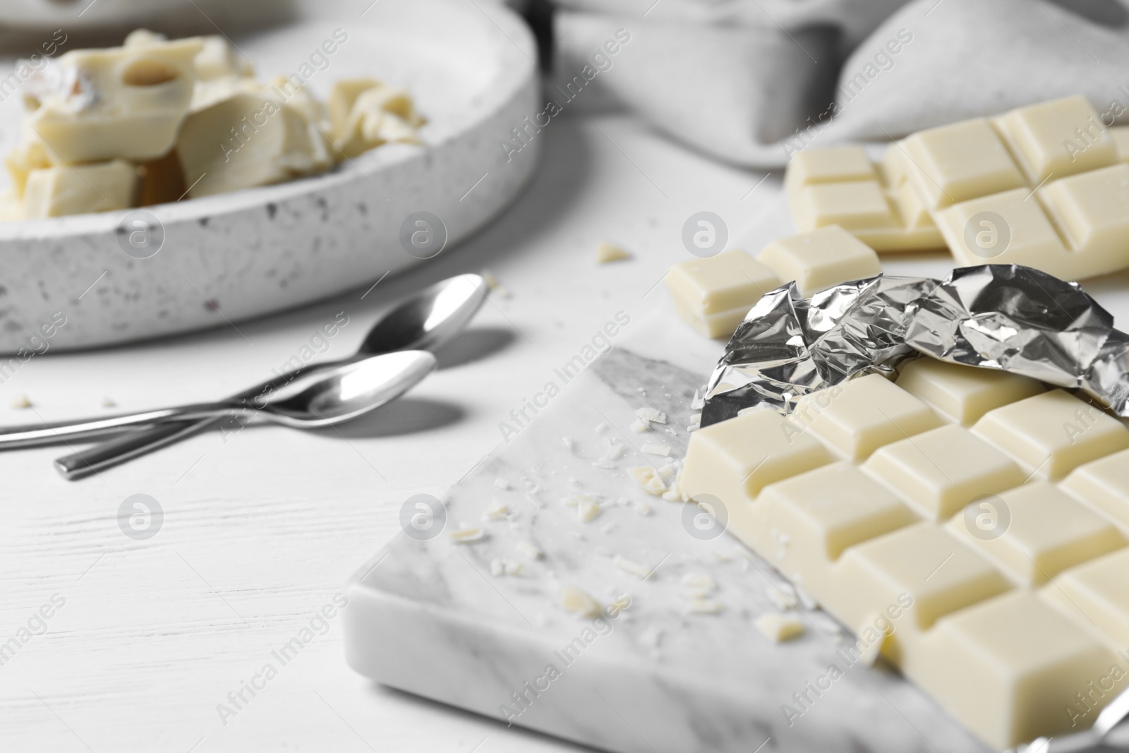 Photo of Tasty white chocolate on wooden table, closeup