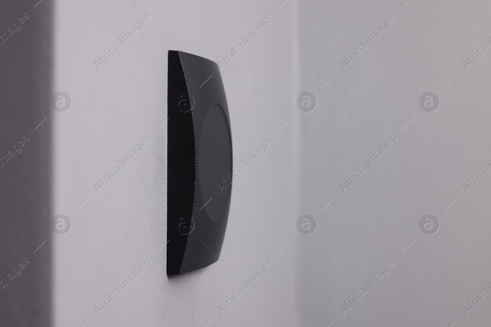 Photo of Magnetic door lock on grey wall, space for text. Home security