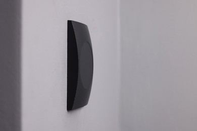 Photo of Magnetic door lock on grey wall, space for text. Home security