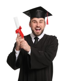 Photo of Emotional student with graduation hat and diploma on white background