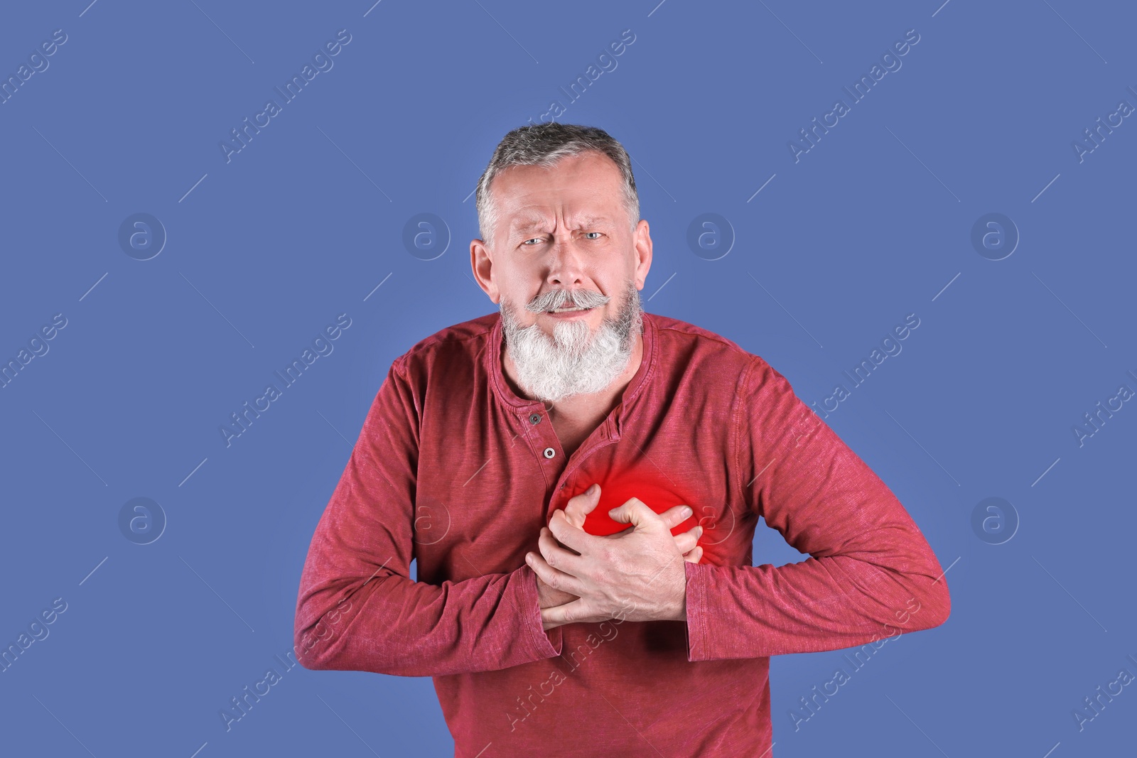 Photo of Mature man having heart attack on color background