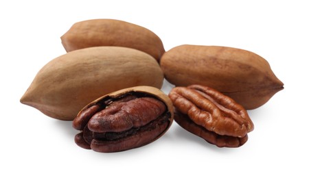 Photo of Many tasty pecan nuts isolated on white