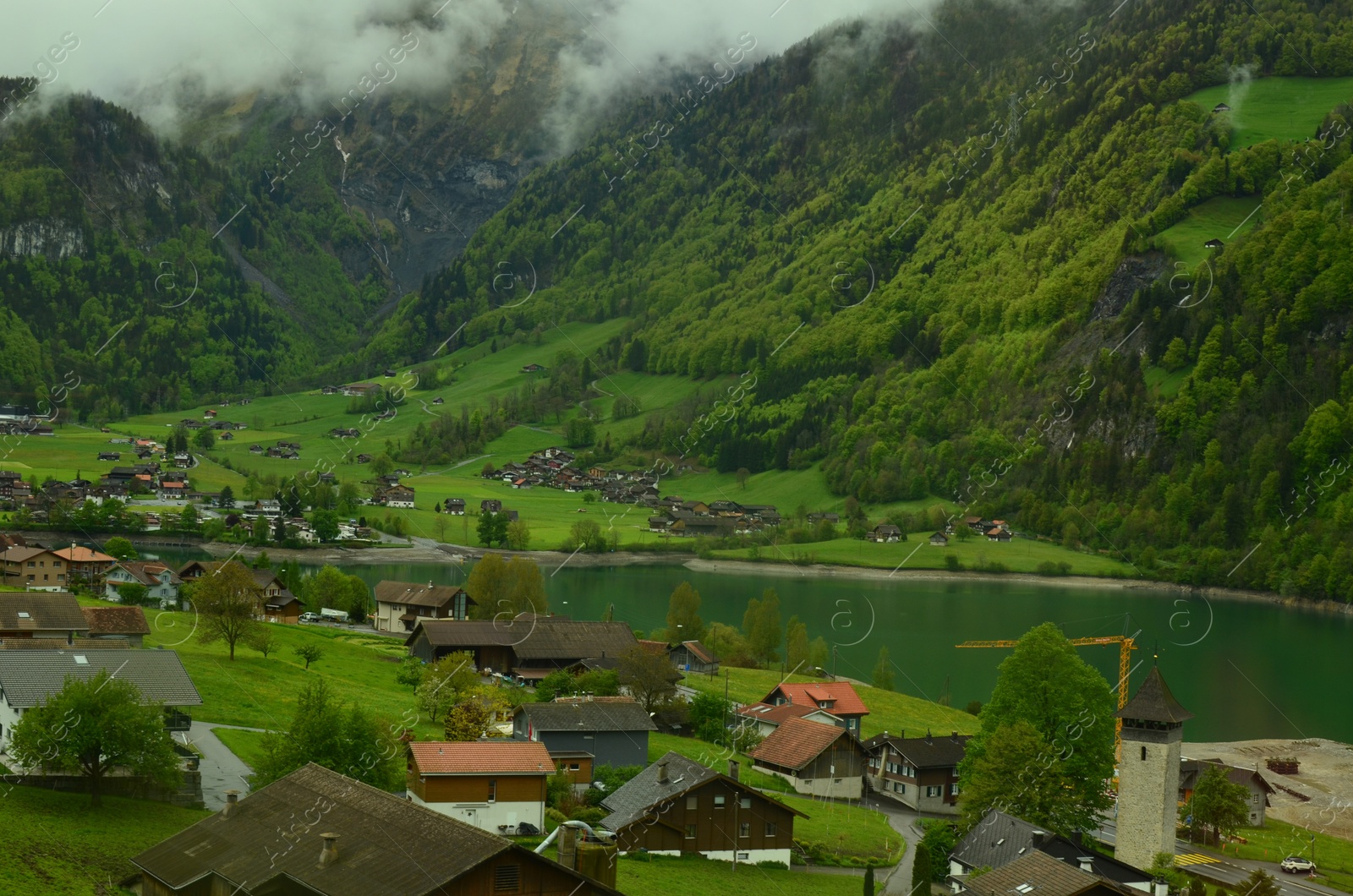 Photo of Picturesque view on cottage village and lake in mountains