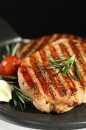 Photo of Delicious grilled pork steaks with spices on table, closeup