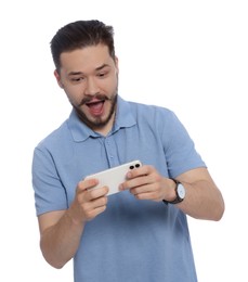 Photo of Emotional man playing game on phone against white background