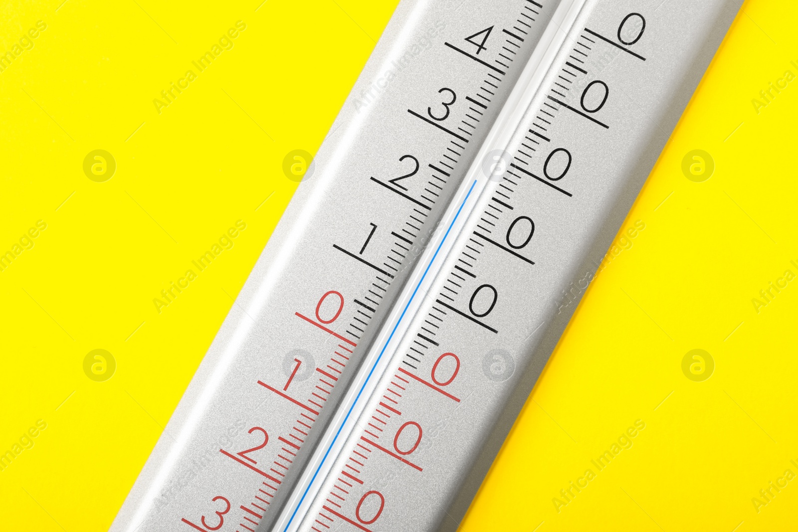 Photo of Modern weather thermometer on yellow background, closeup