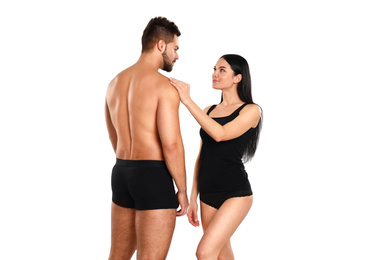 Photo of Young couple in black underwear on white background