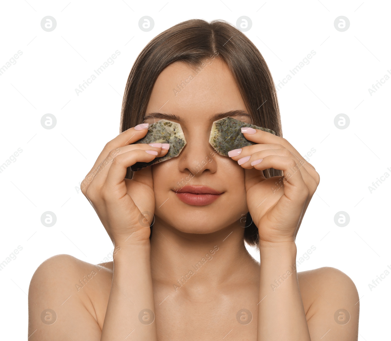 Photo of Young woman with tea bags on white background. Eye skin care