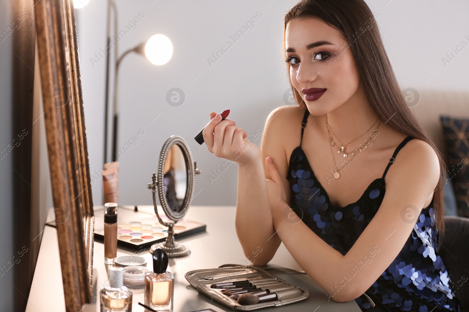 Photo of Portrait of beautiful woman with bright makeup indoors