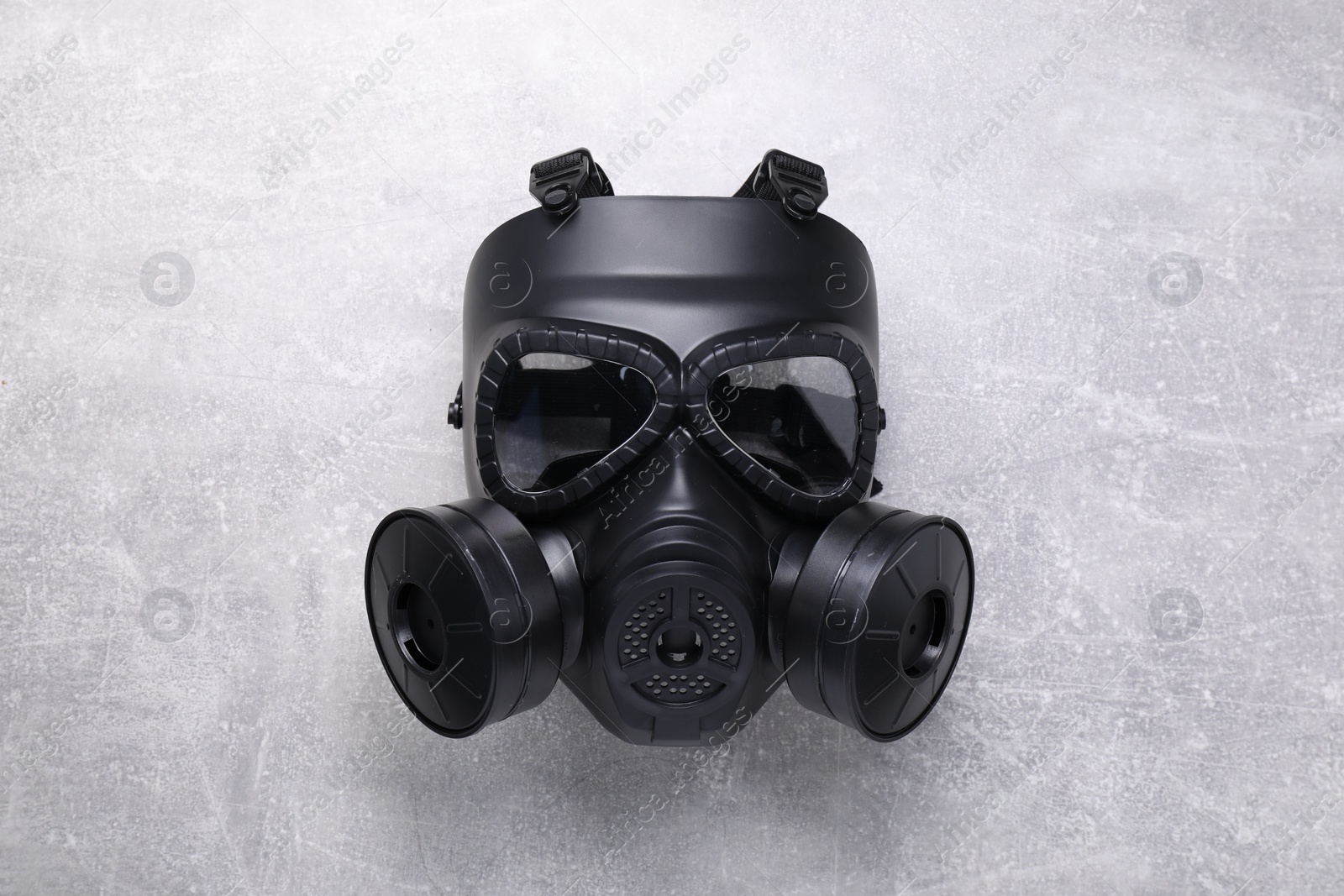 Photo of One gas mask on grey textured background, top view