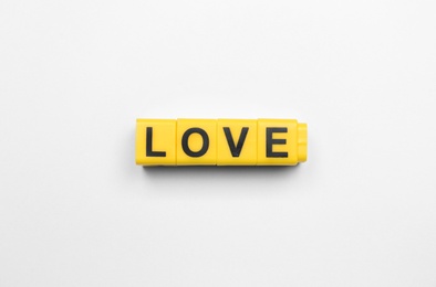 Photo of Cubes with word LOVE on white background, top view