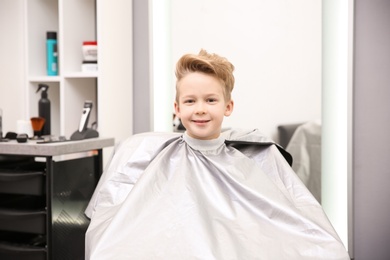 Cute little boy in hairdressing salon