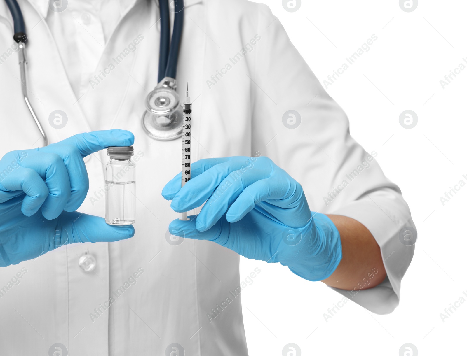 Photo of Doctor holding medical syringe and glass vial on white background, closeup