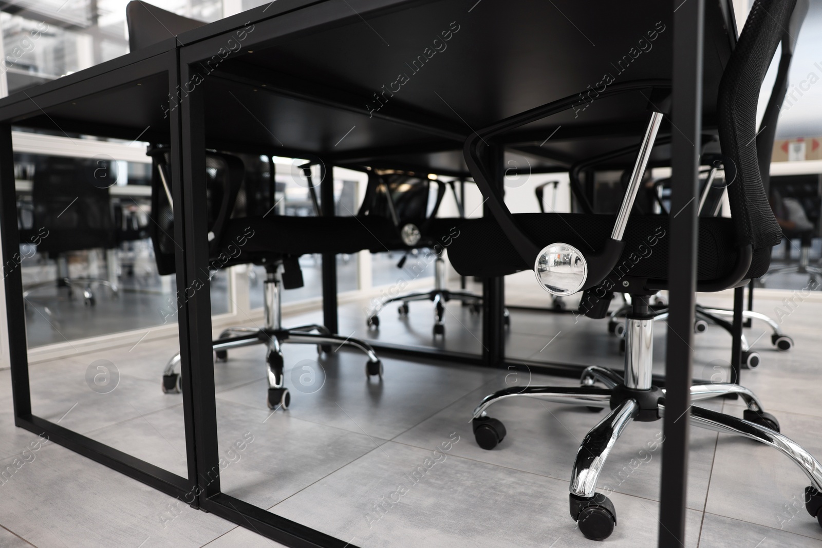 Photo of Comfortable office chairs and tables in meeting room, closeup