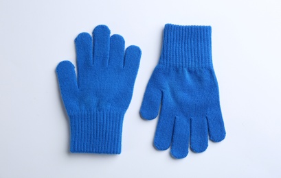 Photo of Pair of stylish woolen gloves on white background, flat lay
