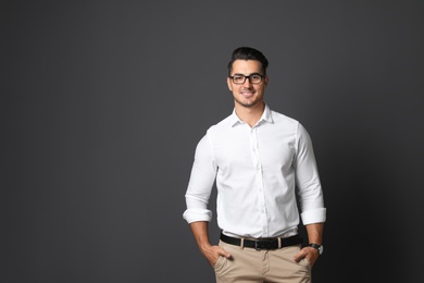 Portrait of handsome young man and space for text on black background