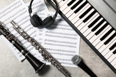 Photo of Flat lay composition with different musical instruments and microphone on light grey background