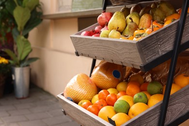 Photo of Fresh ripe fruits in wooden crates at market, space for text