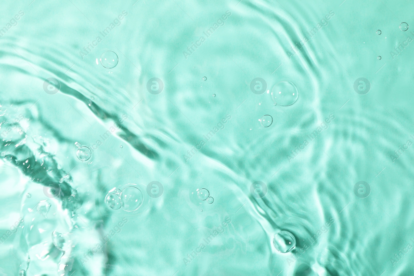 Photo of Closeup view of water with rippled surface on light blue background