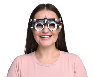 Photo of Vision testing. Young woman with trial frame on white background