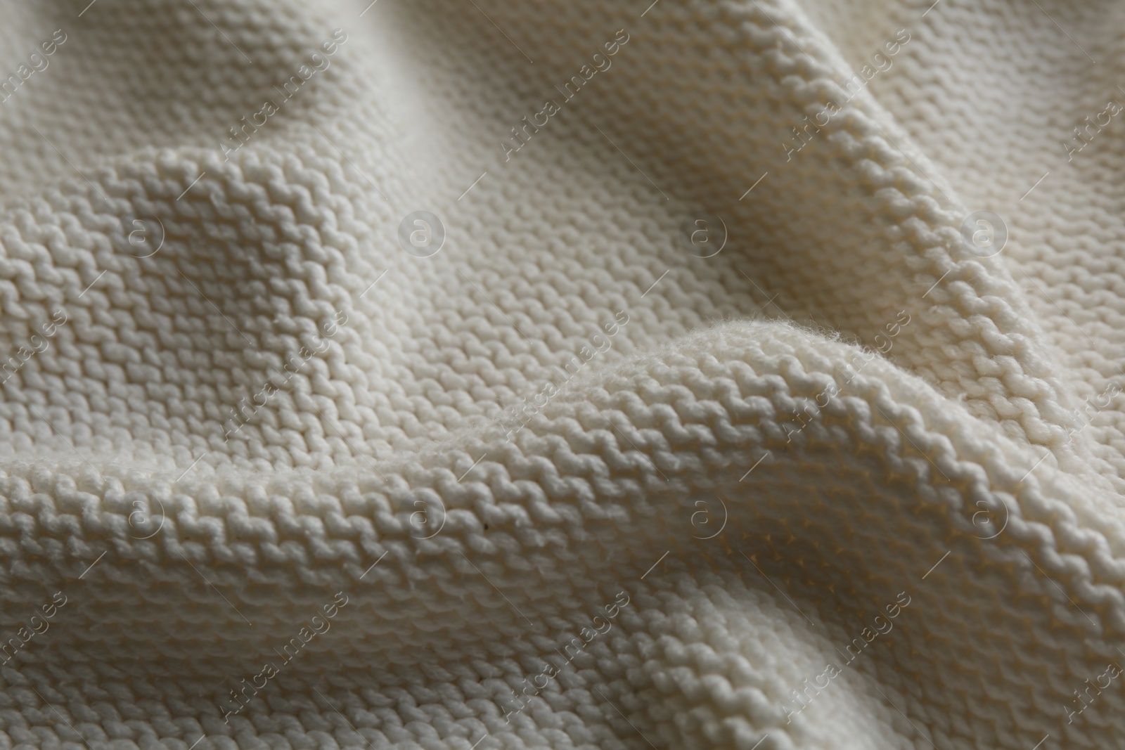 Photo of Beautiful white knitted fabric as background, closeup