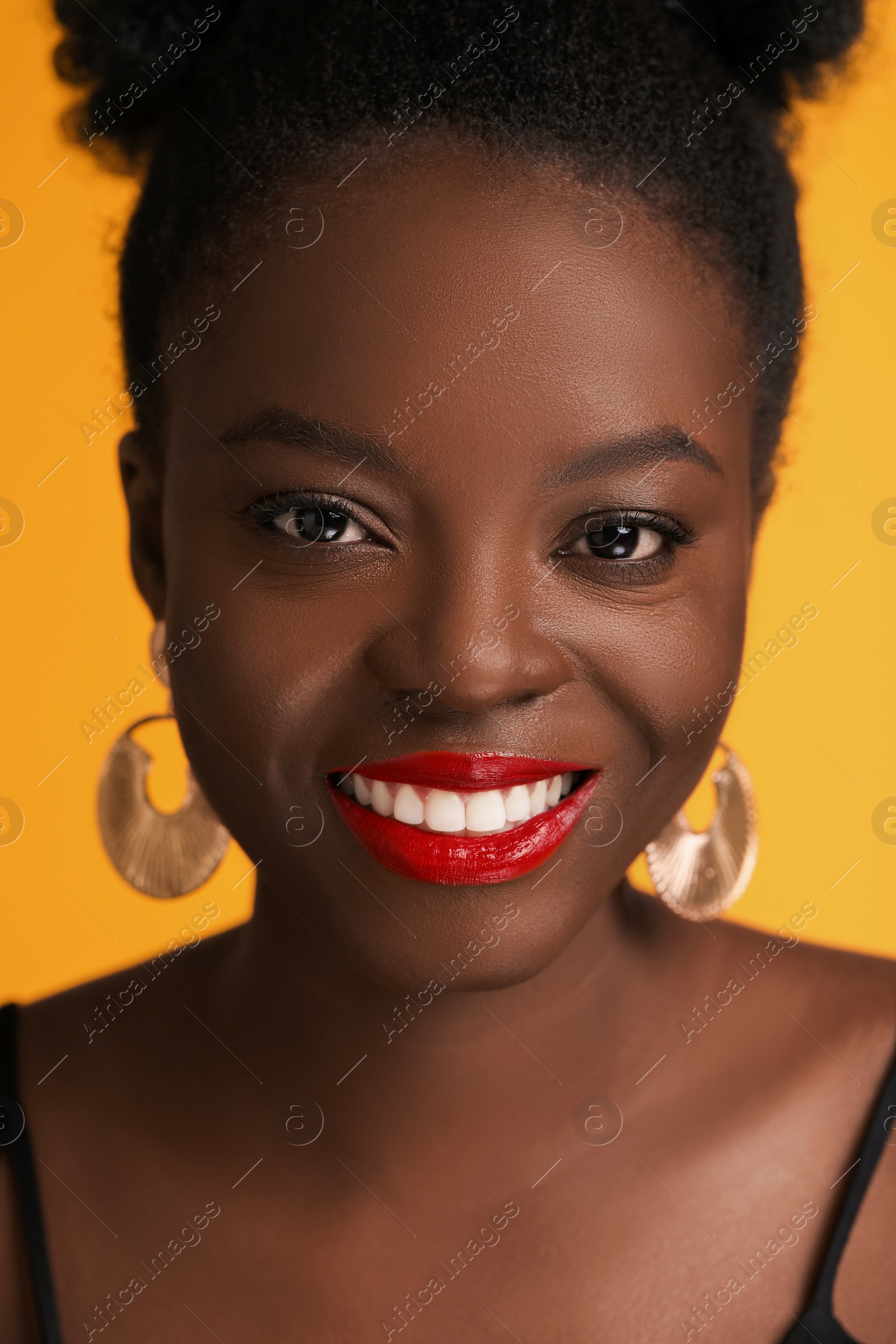 Photo of Fashionable portrait of beautiful happy woman on yellow background, closeup