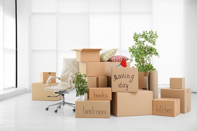 Photo of Pile of moving boxes in empty room