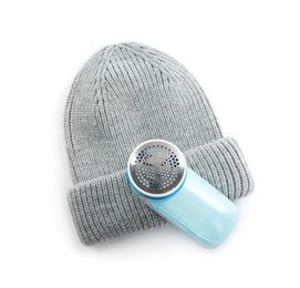 Photo of Modern fabric shaver and woolen hat on white background, top view